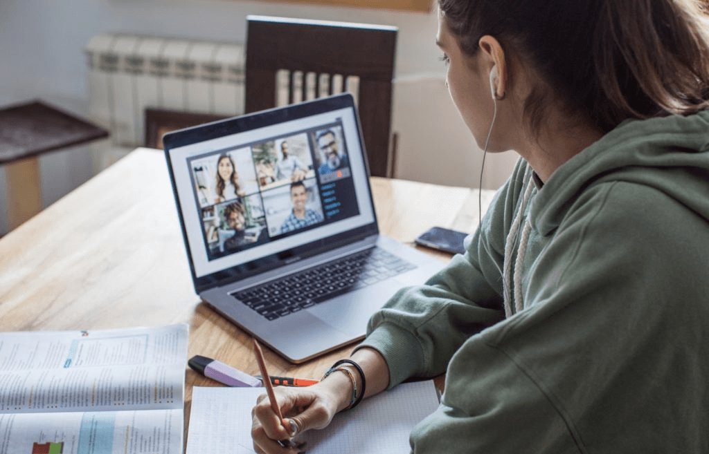 A person attending a webinar or online course, symbolizing continuous learning and adaptation.