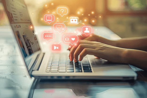 A person typing on a laptop, surrounded by floating icons of content-related items such as a blog, video, and graphics.