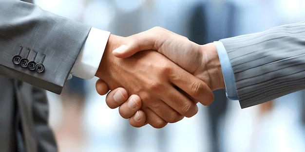 Two businesspeople shaking hands, symbolizing forming strategic partnerships.